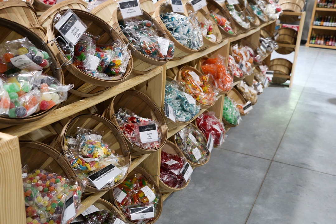 Full baskets of various candies at Baker's Candies.