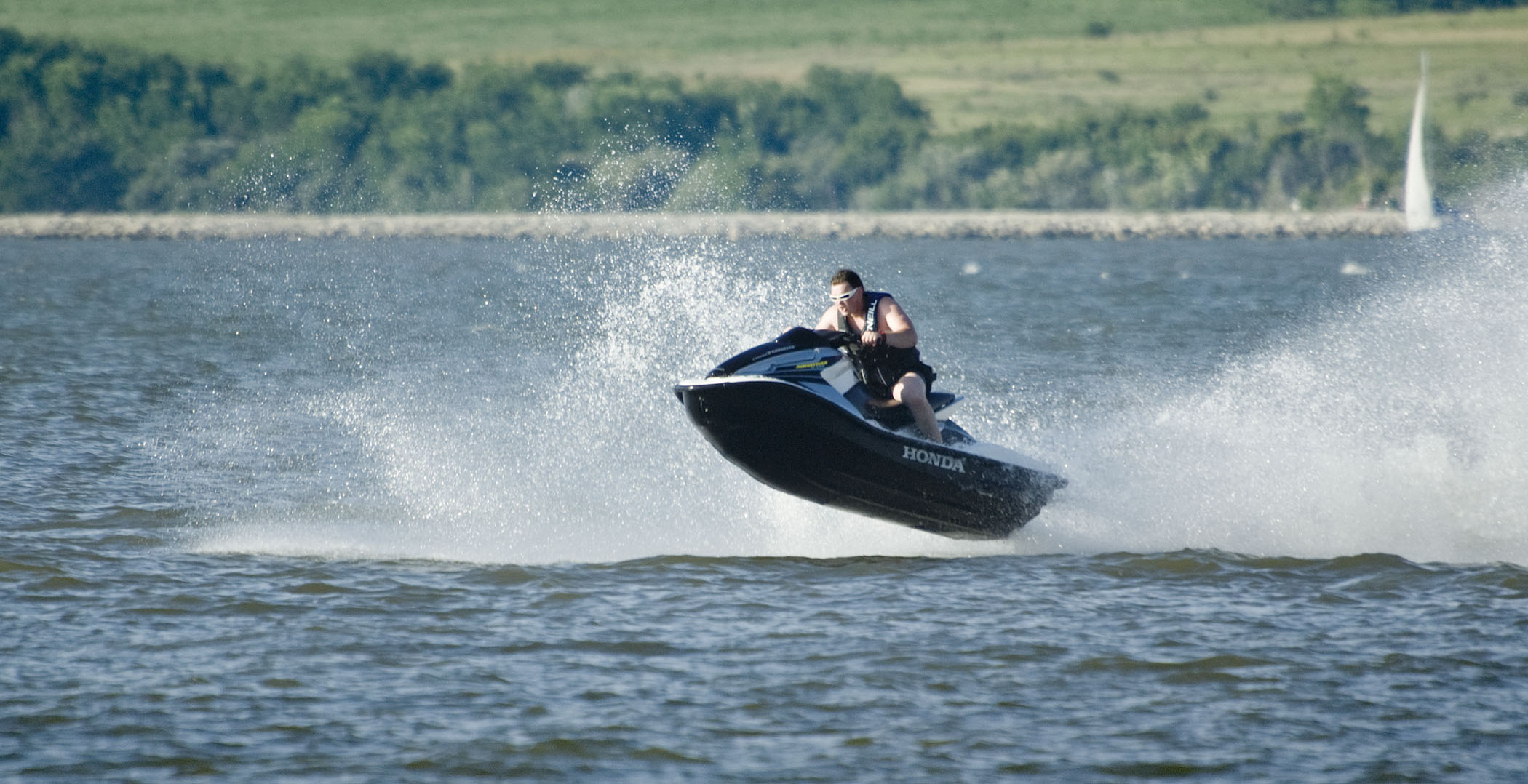 A man on a Jetski skipping the water at Branched Oak Lake.