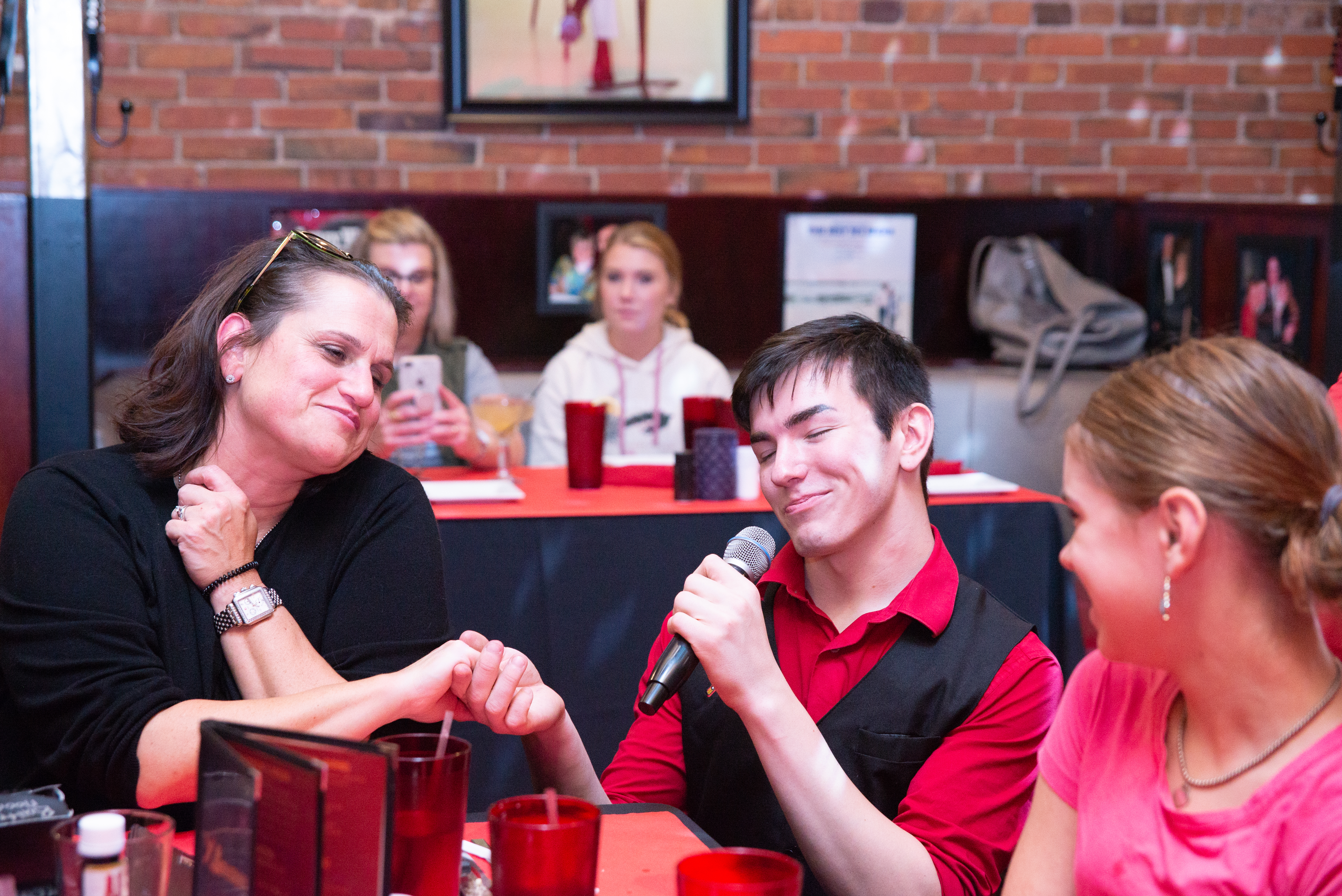 A performer interacting with a guest at Show Stoppers Family Dining & Entertainment.