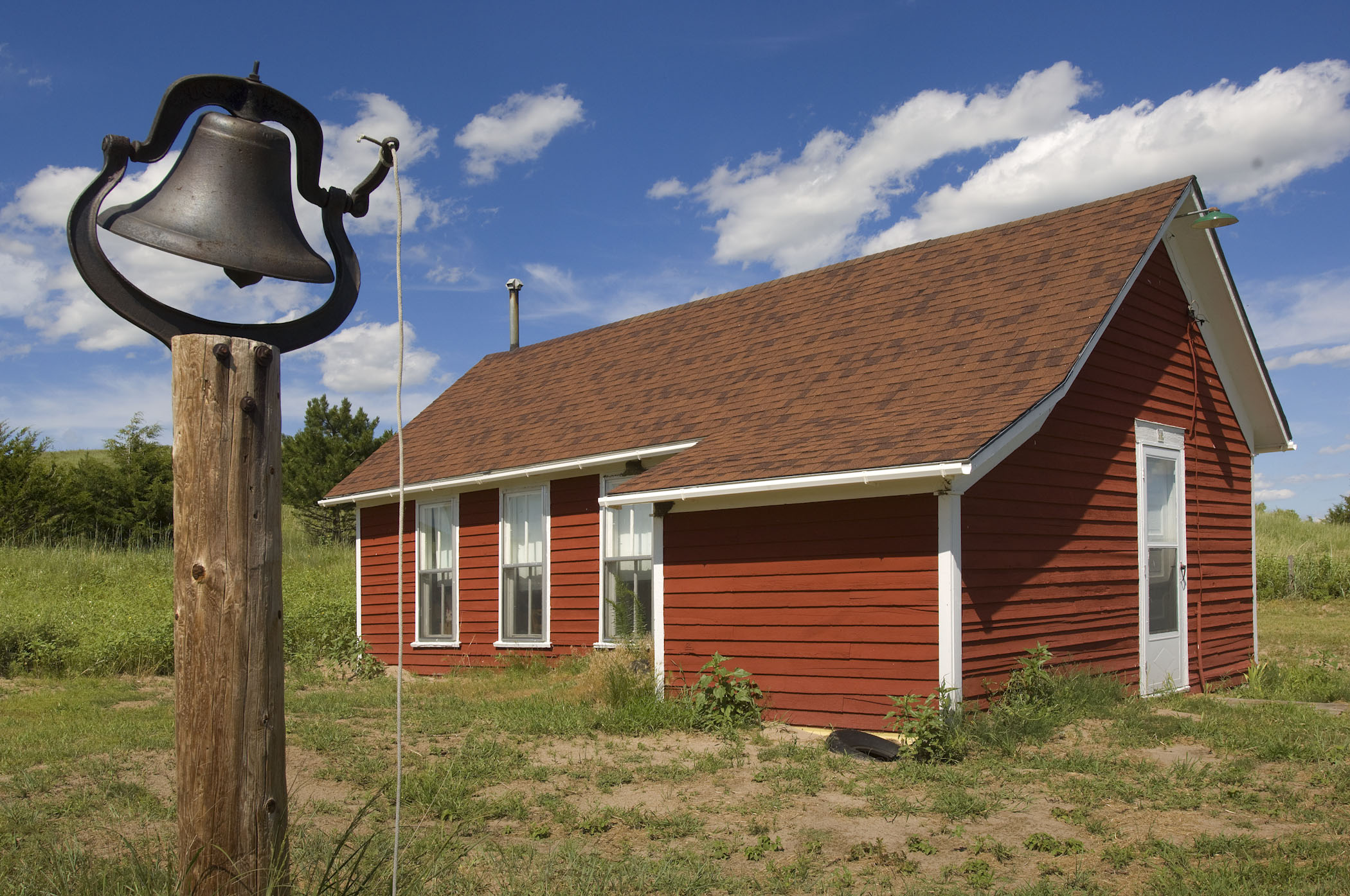 A bell stands ready to ring outside a building at Double R Guest Ranch near Mullen, NE.