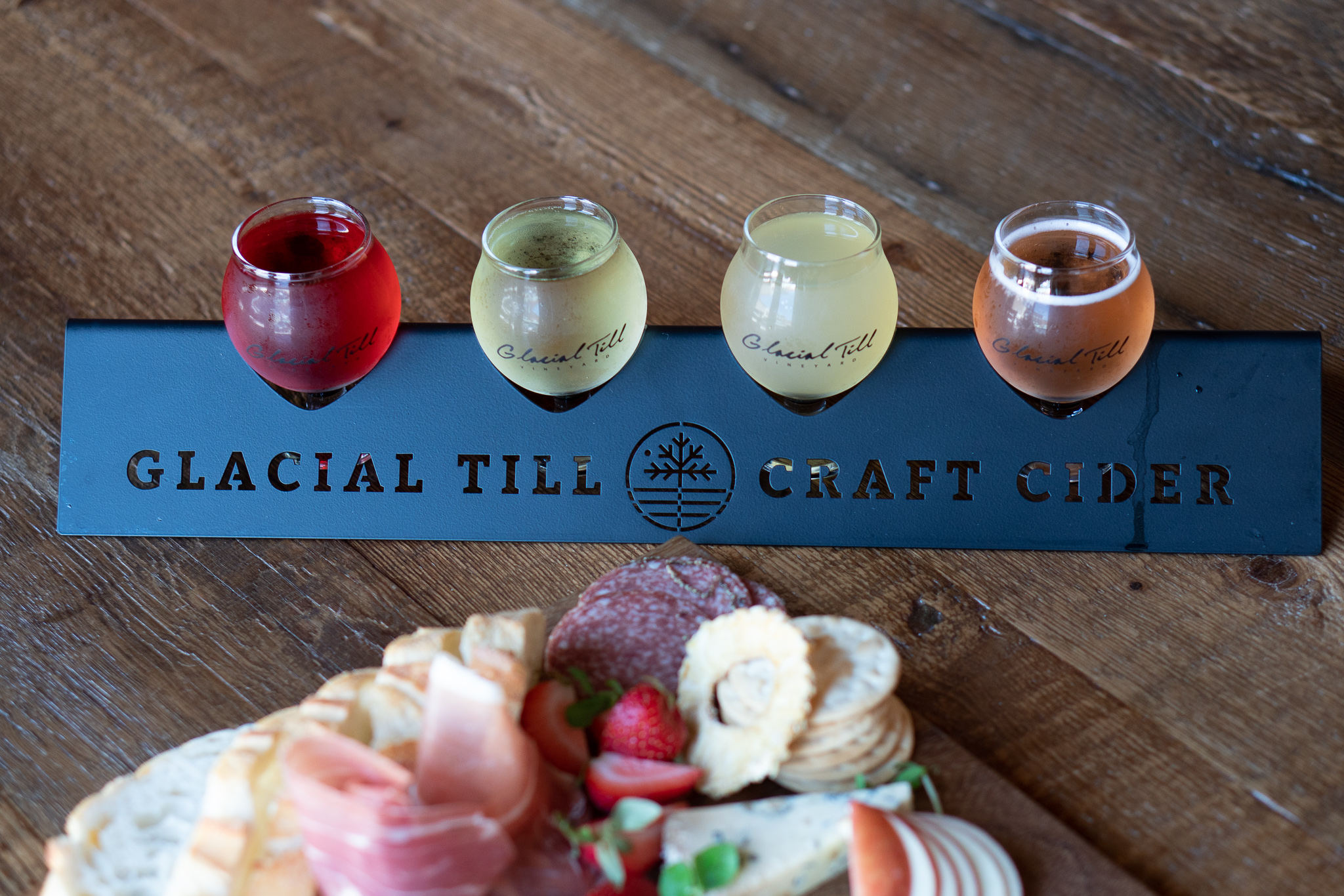 A flight of handcrafted drinks and charcuterie from Glacial Till Cider House & Tasting Room.