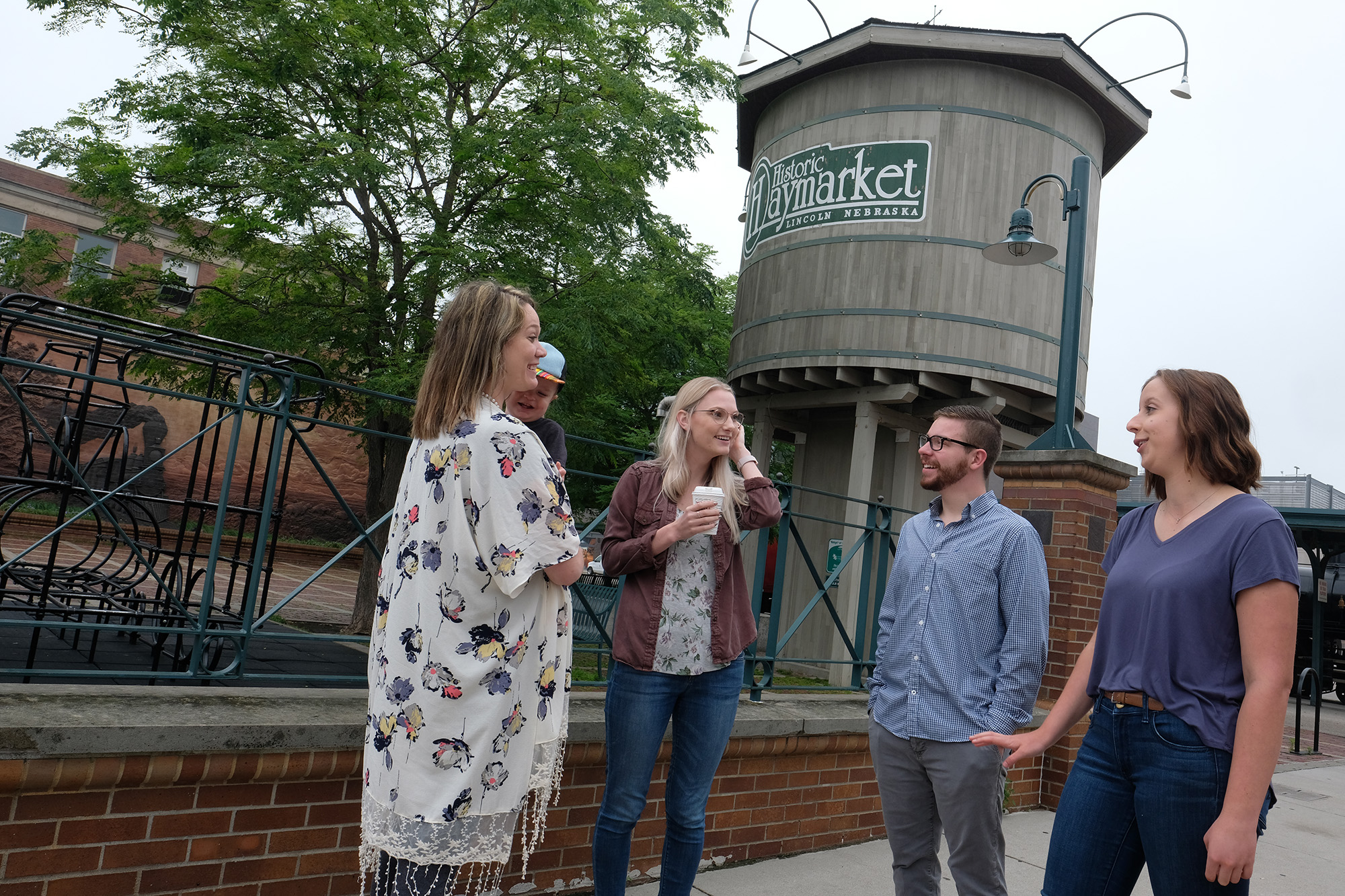 A group of people chatting in Lincoln's Historic Haymarket District.