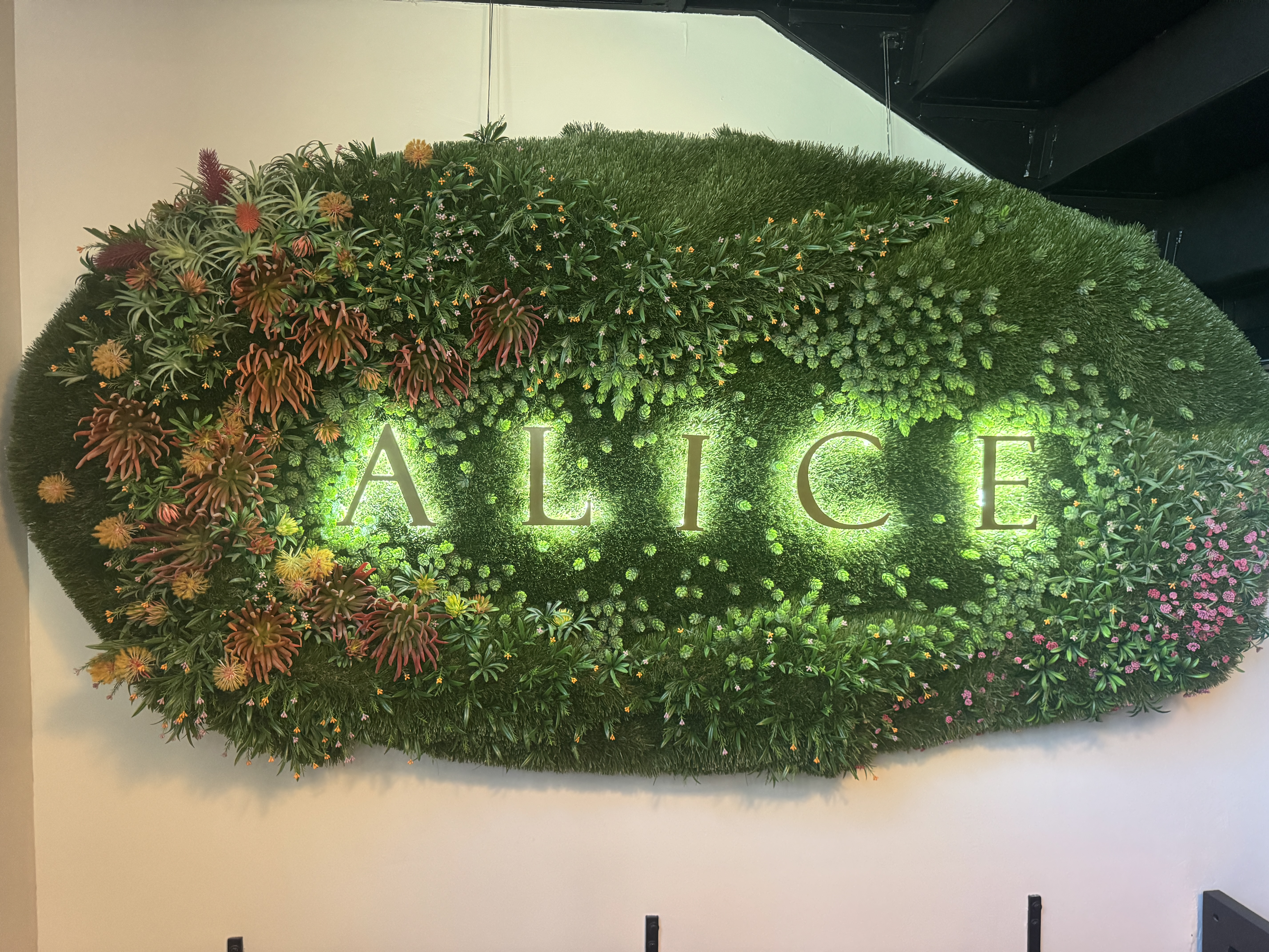 The floral "Alice" speakeasy sign.