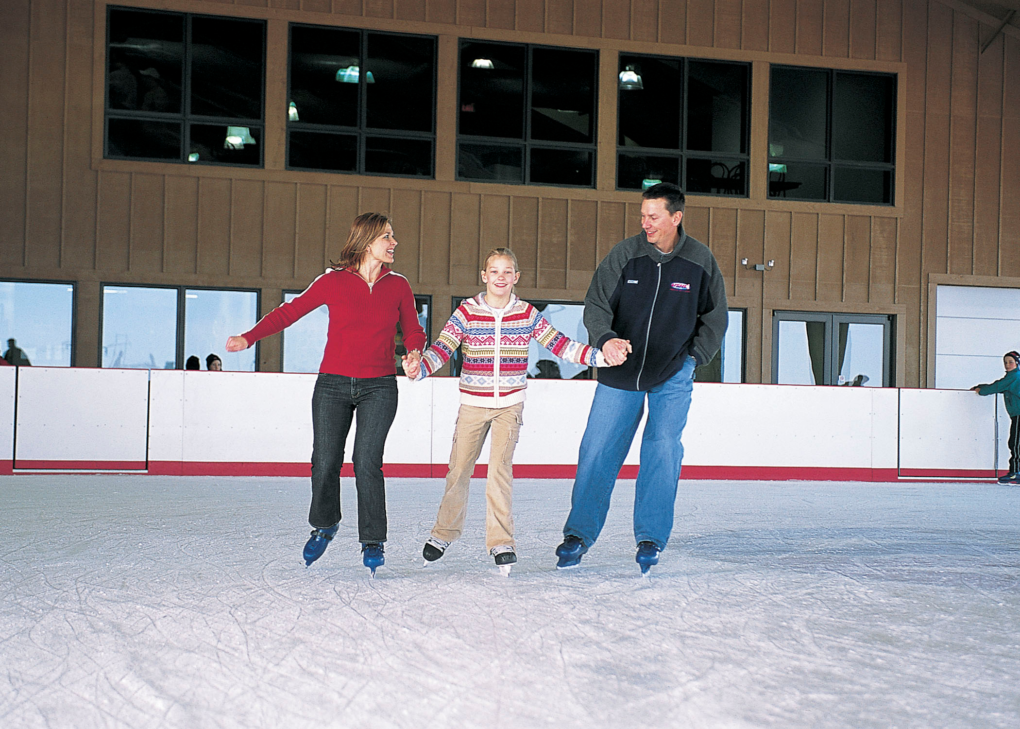 A family of three ice skating at Mahoney State Park in Ashland.