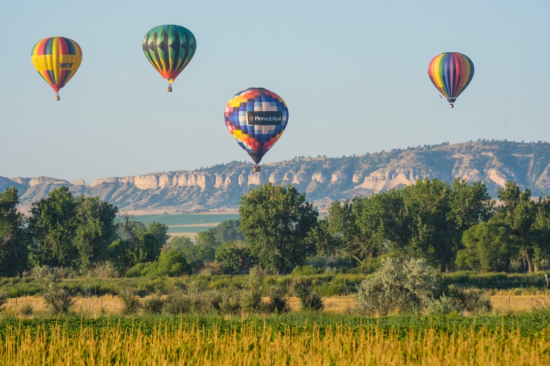 Hot air balloons above Scotts Bluff National Monument at Old West Balloon Fest.