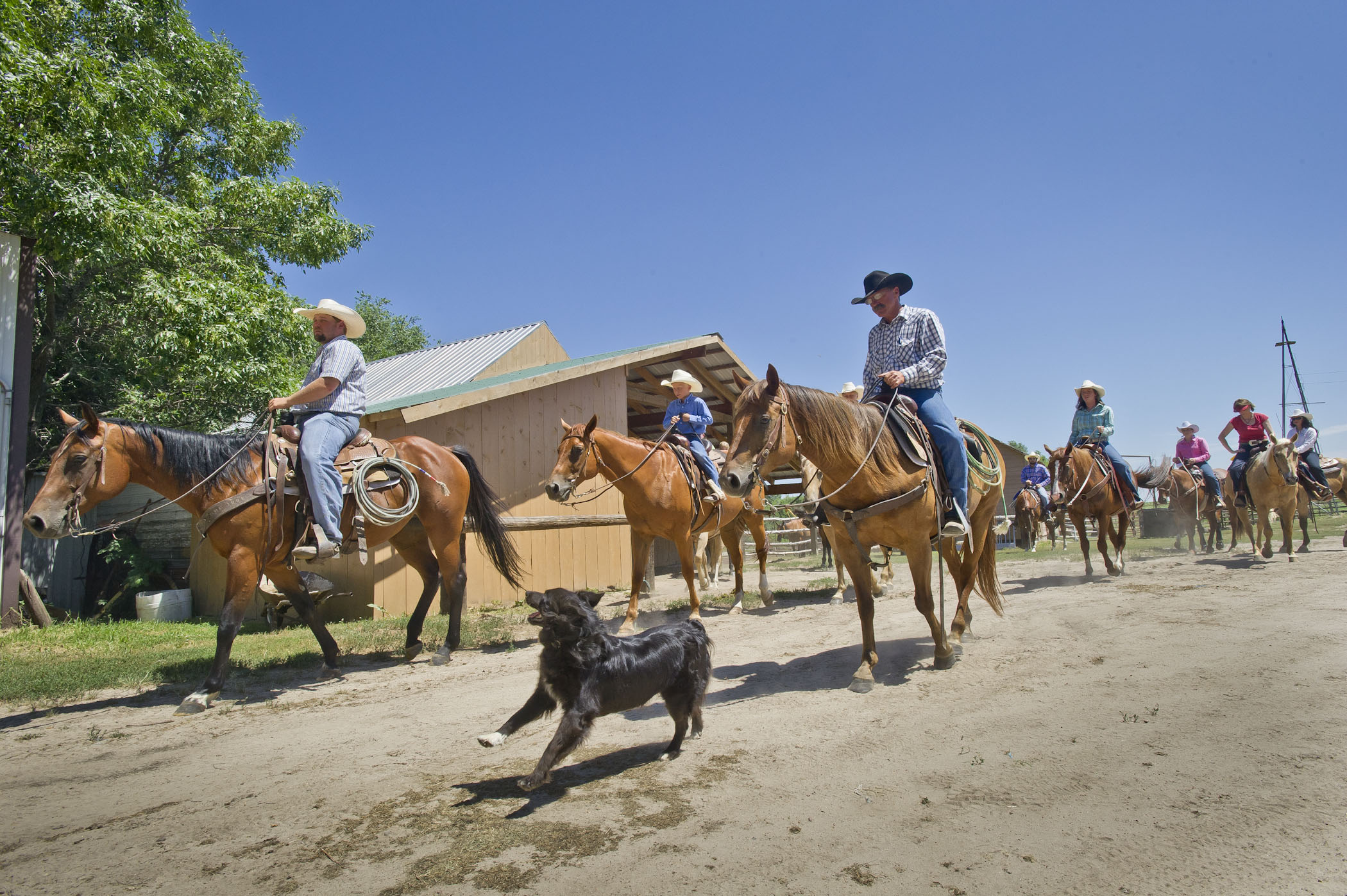 A group of horseback riders travel along a dirt path at Rowse's 1+1 Ranch in Burwell, NE.