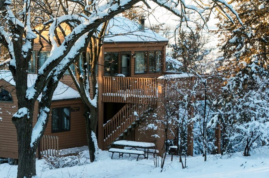 A cabin in a snowy setting at Eugene T. Mahoney State Park