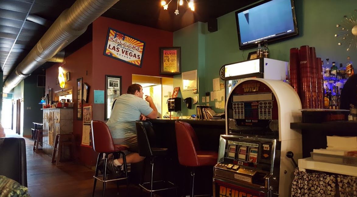 A man eating at the bar at Sin City Grill.
