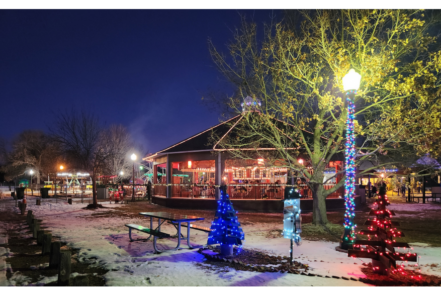The carousel, light poles and displays aglow with festive lights at Cody Park, decorated for the holidays.