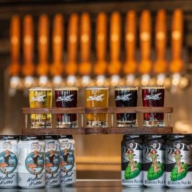 Pint flight and beer products on display.
